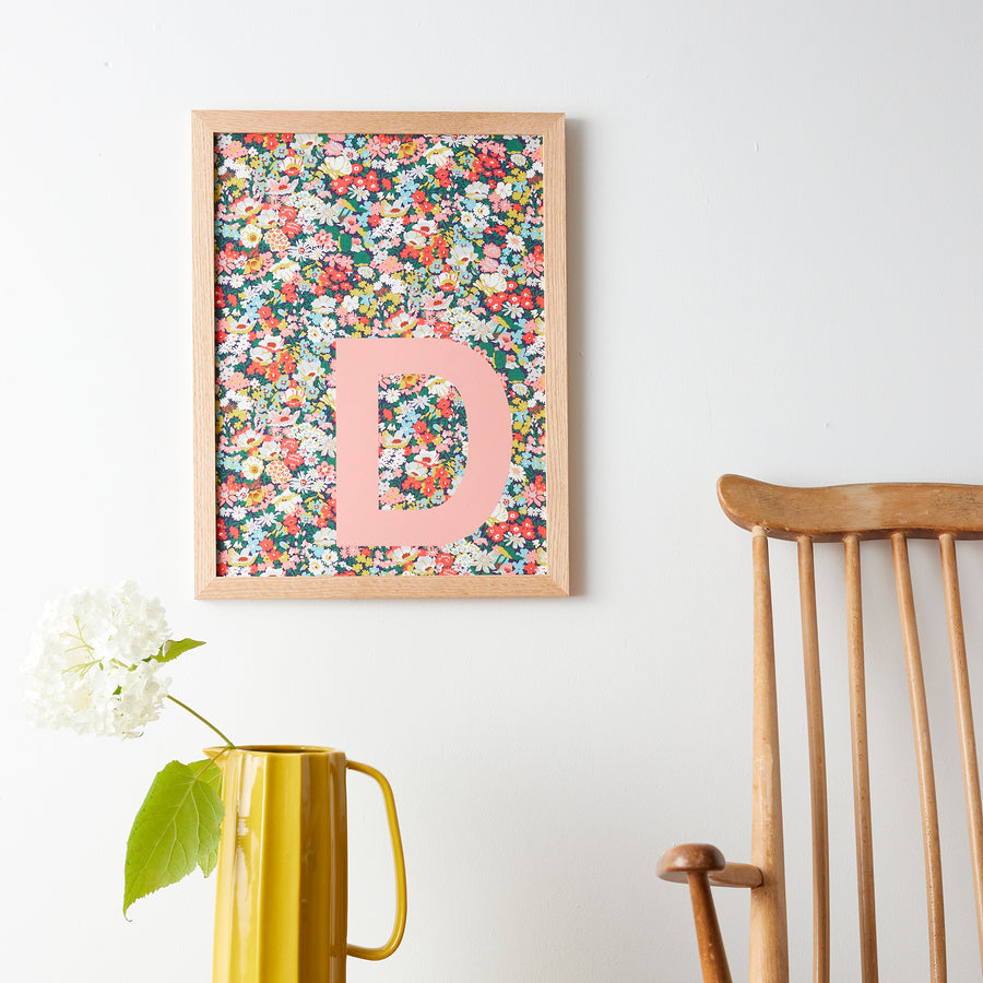 Catherine Colebrook framed Liberty initial picture, in Thorpe Tana Mustard fabric with salmon pink letter, in an oak frame