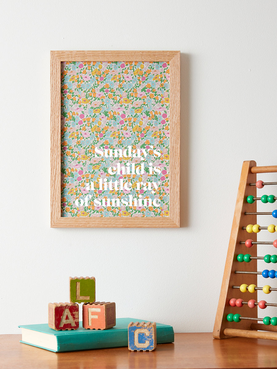Catherine Colebrook framed Liberty ‘Sunday’s Child’ nursery rhyme quote picture, in Poppy Forest Liberty Tana Lawn with white text, in an oak frame