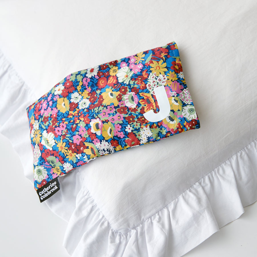 Catherine Colebrook dark pink Liberty eye pillow with white initial on the bottom right with optional lavender