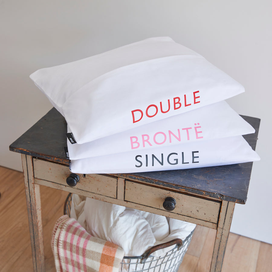 CATHERINE COLEBROOK BEDDING BAGS STACKED UP