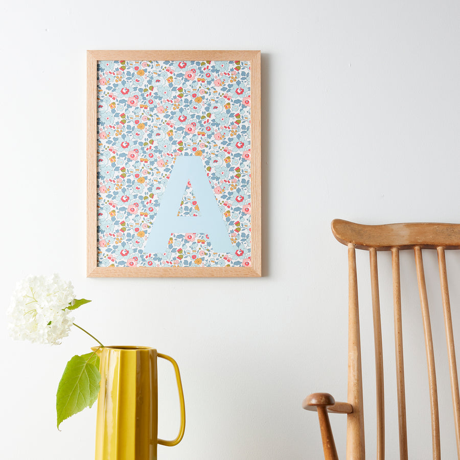 Catherine Colebrook framed Liberty initial picture, in Betsy Blue fabric with pale blue letter, in an oak frame