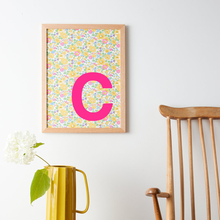 Catherine Colebrook framed Liberty initial picture, in Betsy Yellow fabric with neon pink letter, in an oak frame