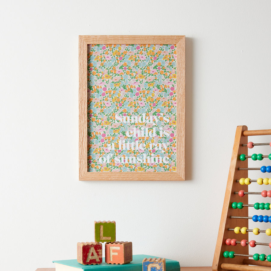 Catherine Colebrook framed Liberty ‘Sunday’s Child’ nursery rhyme quote picture, in Poppy Forest Liberty Tana Lawn with white text, in an oak frame