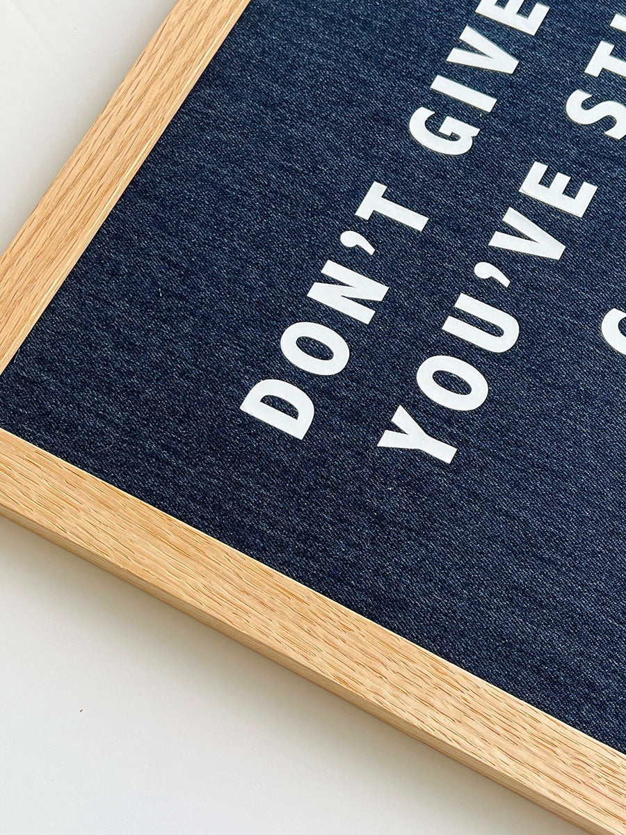 Catherine Colebrook framed denim quote picture, ‘Motherfuckers' in denim with white text, in an oak frame - close up