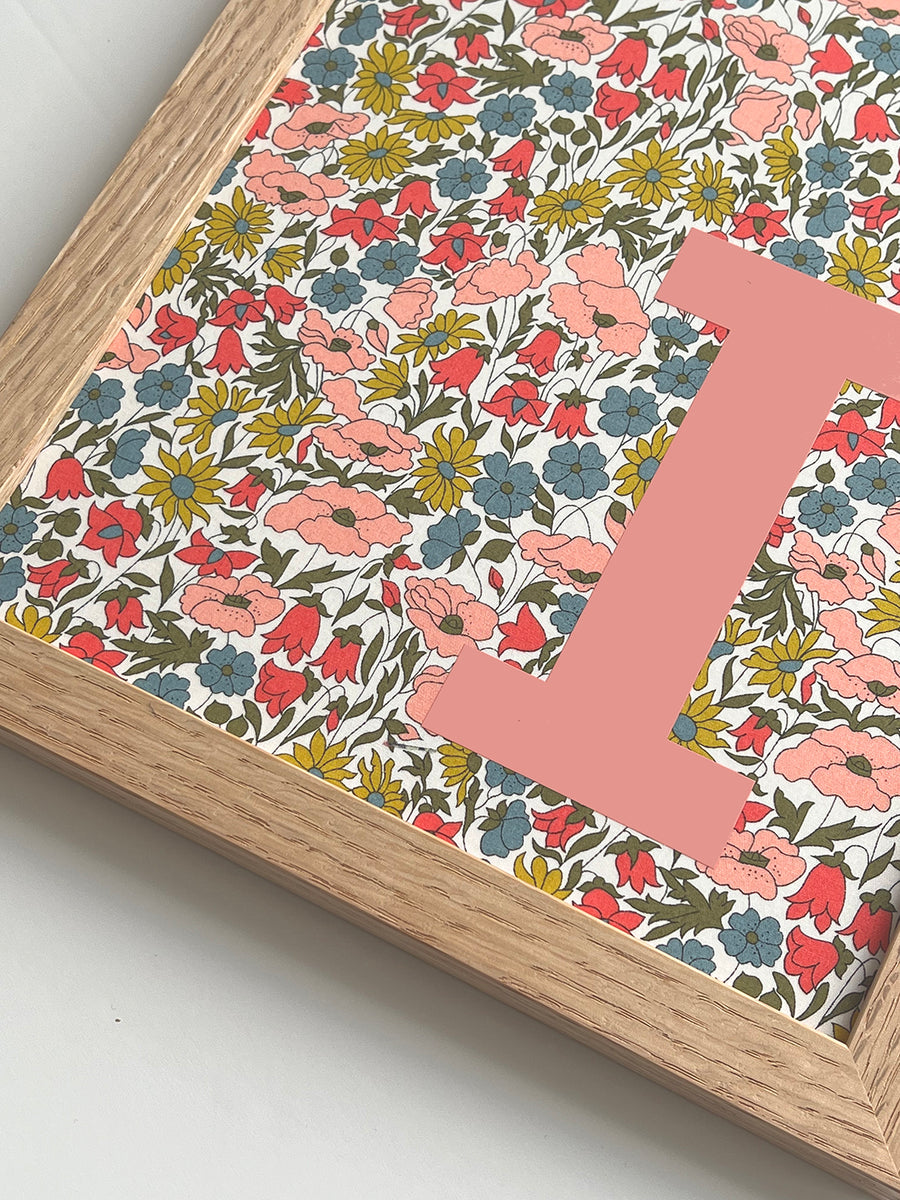 Catherine Colebrook framed Liberty initial picture, in Poppy & Daisy fabric with salmon pink letter, in an oak frame - close up