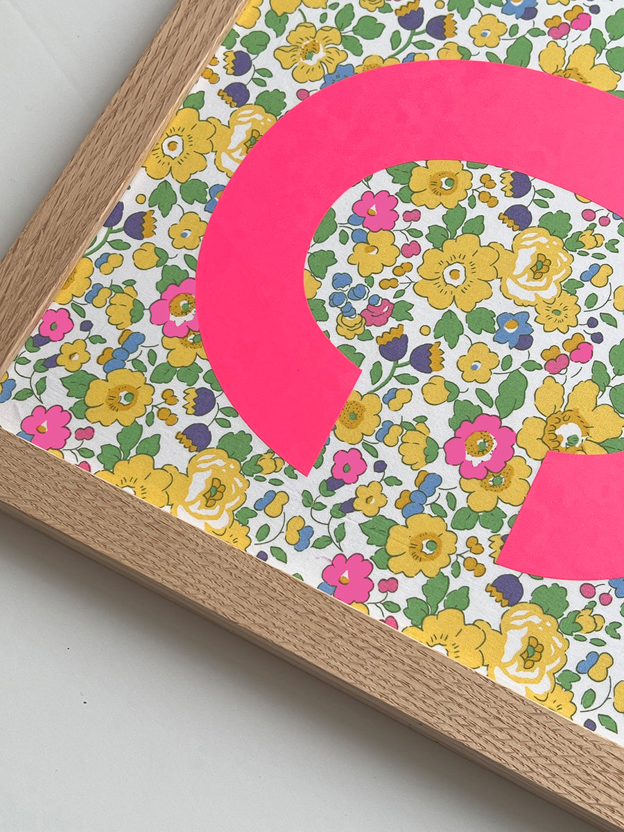 Catherine Colebrook framed Liberty initial picture, in Betsy Yellow fabric with neon pink letter, in an oak frame - close up