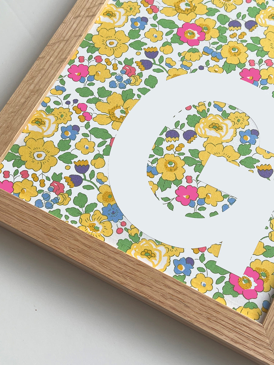 Catherine Colebrook framed Liberty initial picture, in Betsy Yellow fabric with white letter, in an oak frame - close up
