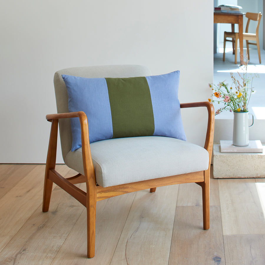 CATHERINE COLEBROOK TRIPLE COLOUR BLOCK CUSHION IN DENIM JUNGLE ON A CHAIR