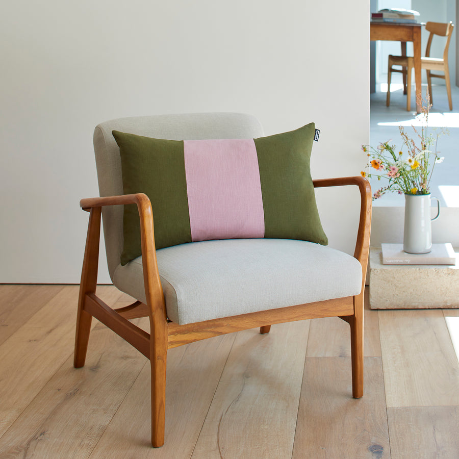 CATHERINE COLEBROOK TRIPLE COLOUR BLOCK CUSHION IN DUSKY JUNGLE ON A CHAIR