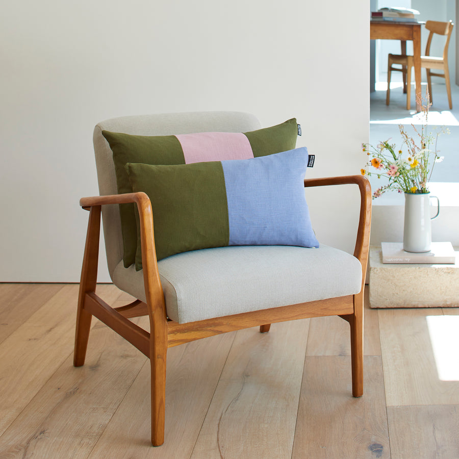 CATHERINE COLEBROOK TRIPLE COLOUR BLOCK CUSHION IN DUSKY JUNGLE ON A CHAIR WITH THE DENIM JUNGLE DOUBLE BLOCK CUSHION