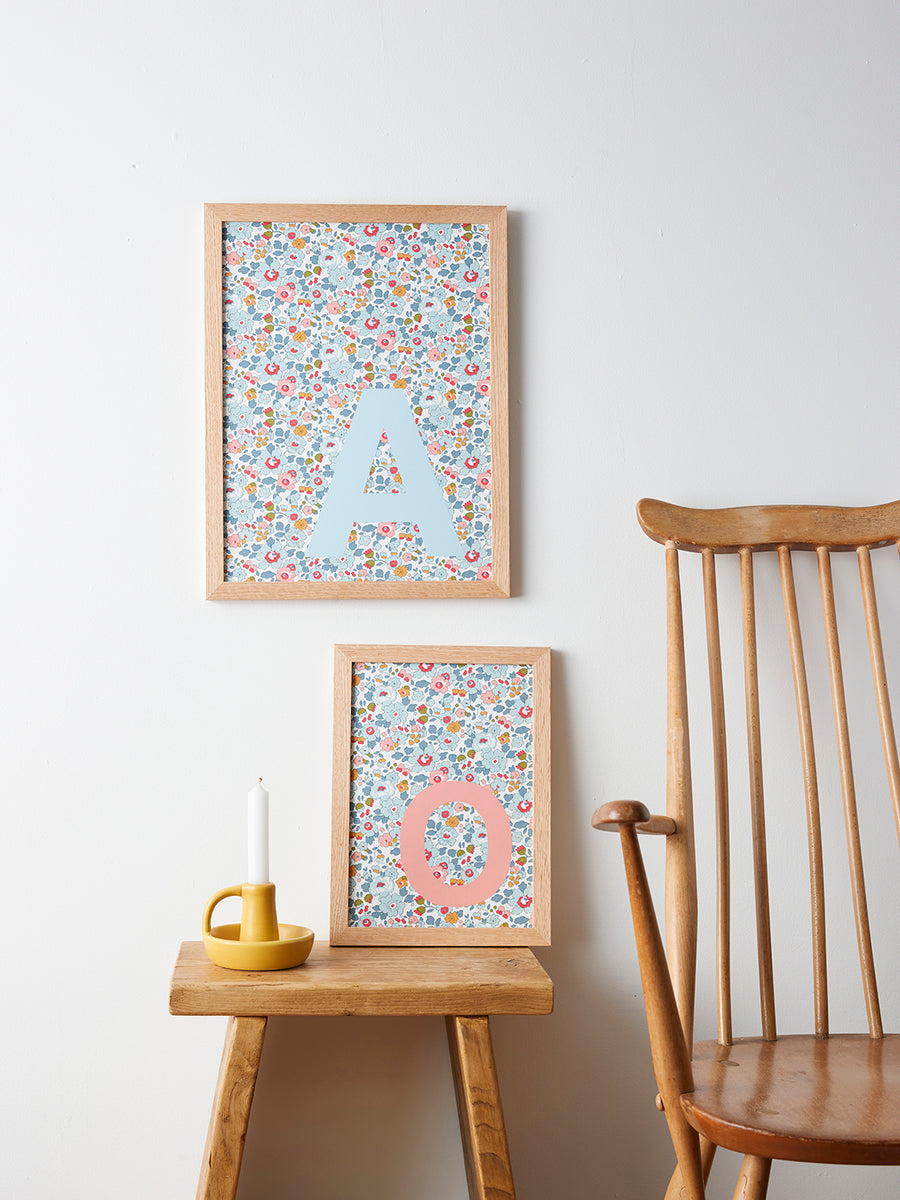 Catherine Colebrook framed Liberty initial picture, in Betsy Blue fabric with pale blue letter and salmon letter,  in an oak frame