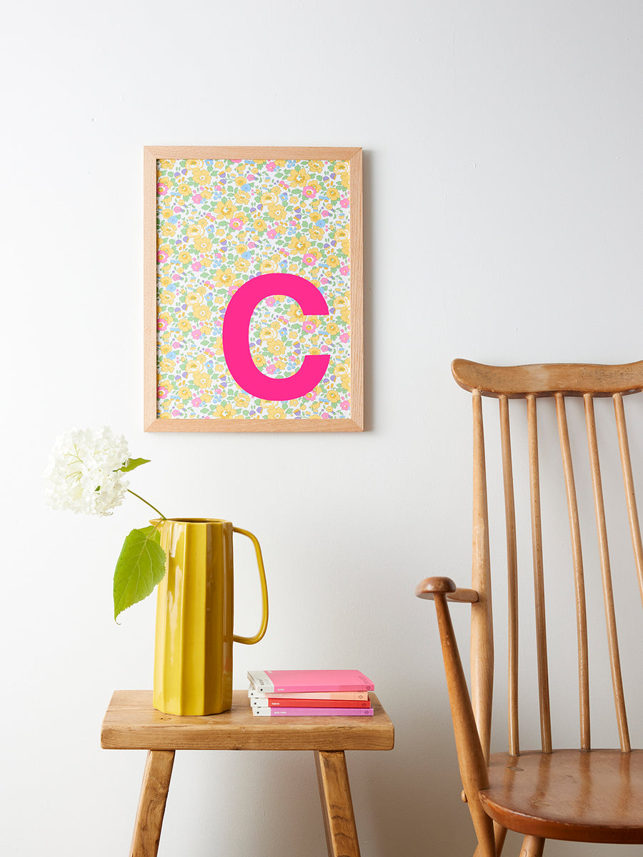 Catherine Colebrook framed Liberty initial picture, in Betsy Yellow fabric with neon pink letter, in an oak frame