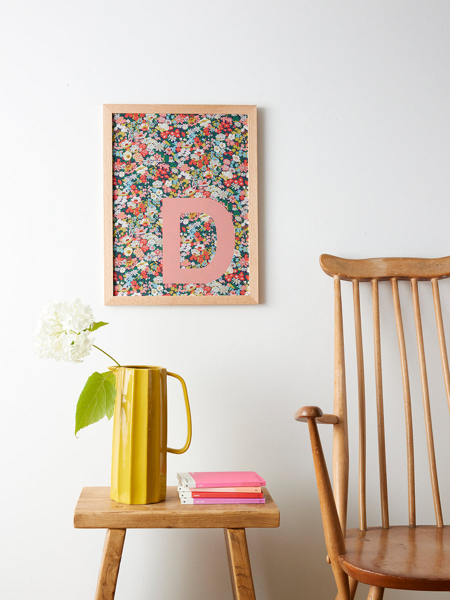 Catherine Colebrook framed Liberty initial picture, in Thorpe Tana Mustard fabric with salmon pink letter, in an oak frame