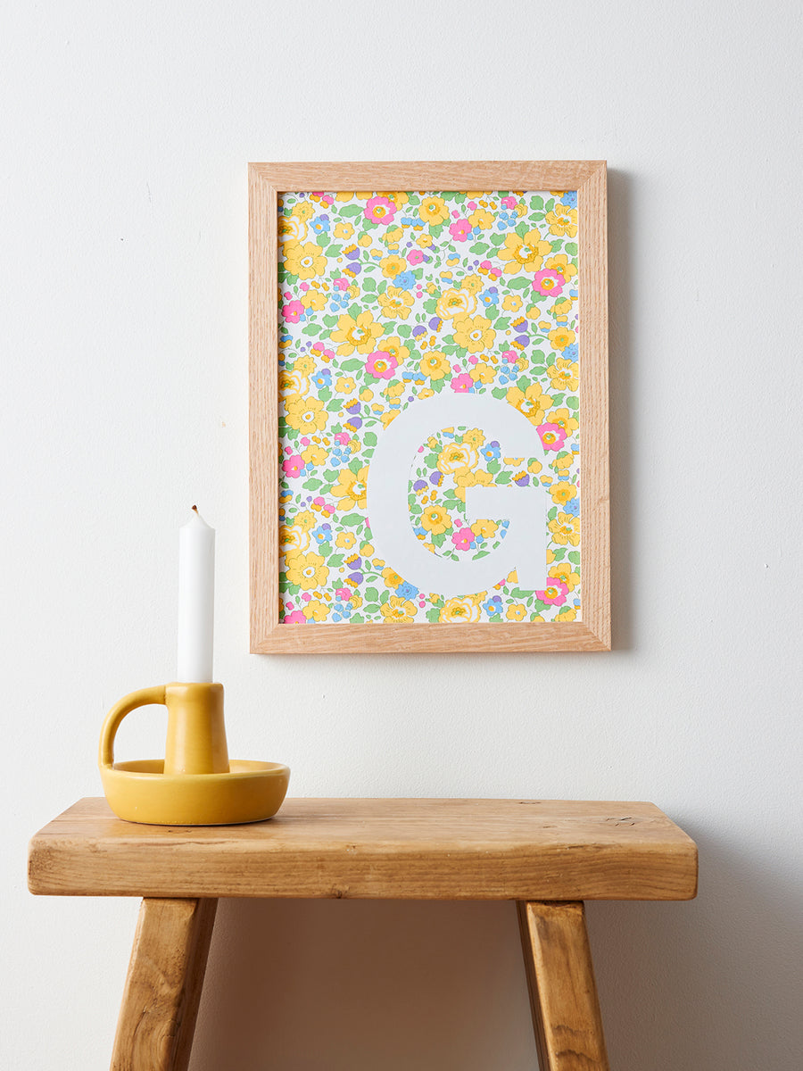 Catherine Colebrook framed Liberty initial picture, in Betsy Yellow fabric with white letter, in an oak frame