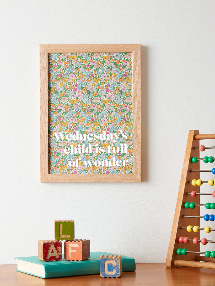 Catherine Colebrook framed Liberty ‘Wednesday’s Child’ nursery rhyme quote picture, in Poppy Forest Liberty Tana Lawn with white text, in an oak frame