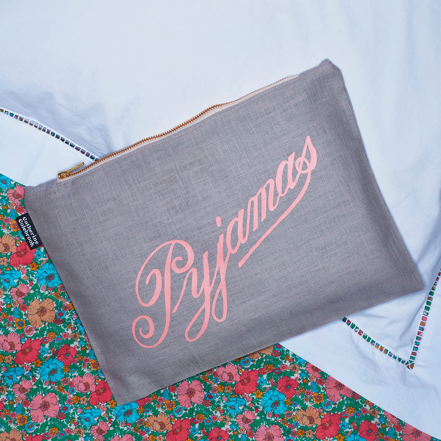 Catherine Colebrook grey linen pyjama case with salmon pink vintage ‘Pyjamas' on the front and zip detail