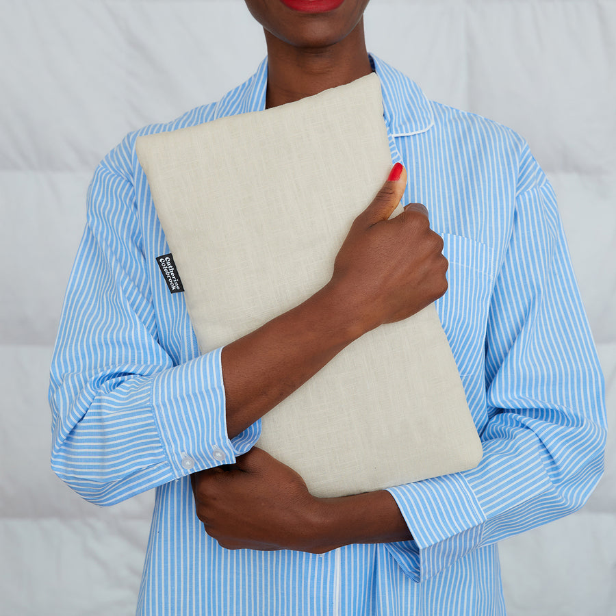 woman hugging natural linen hot water bottle