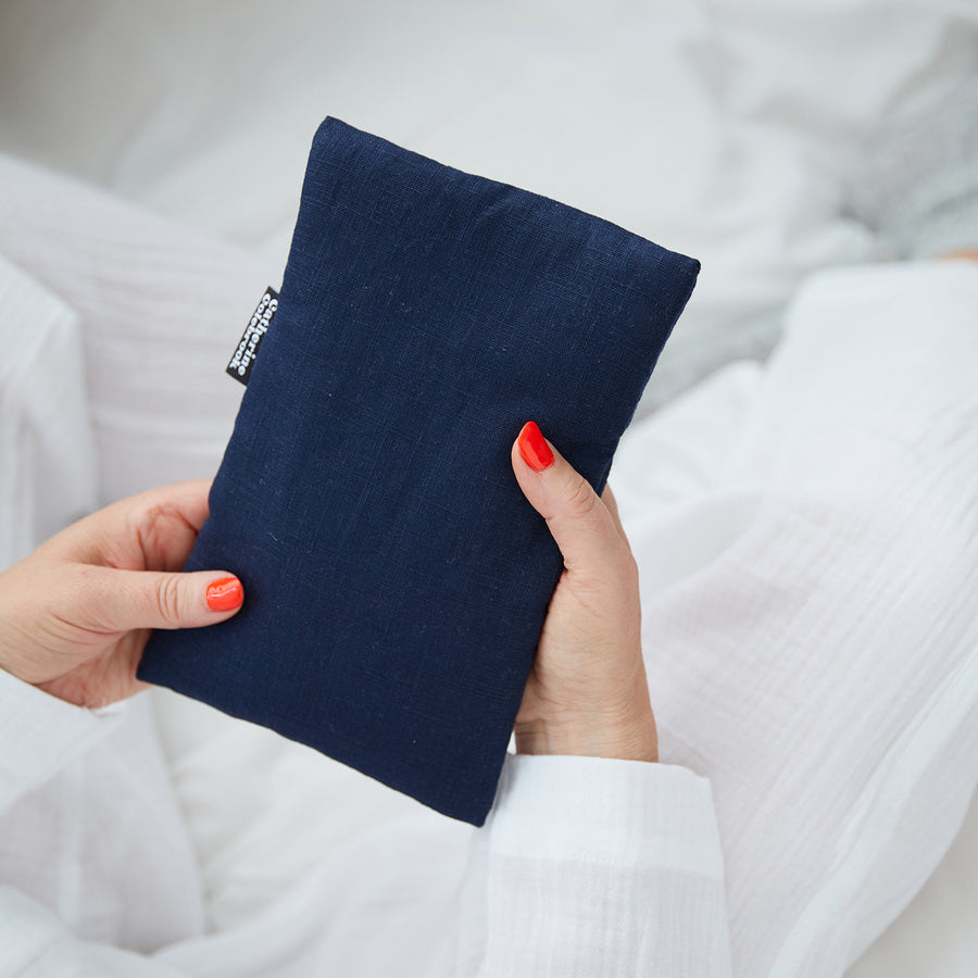 Hand holding cute hot water bottle in Navy Linen.