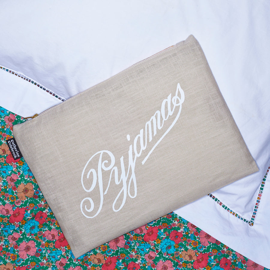 Catherine Colebrook natural linen pyjama case with white vintage ‘Pyjamas’ text on the front and zip detail