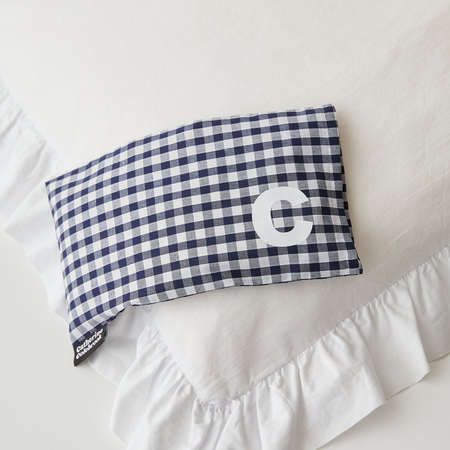 Catherine Colebrook navy gingham eye pillow with white initial on the bottom right with optional lavender